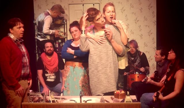 Six characters crammed in a small bathroom, with Herman and Sam brushing their teeth, and Teacup Gorilla playing instruments in the bathtub.